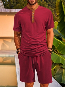 Detail of burgundy textured jacquard fabric and contrasting brown henley collar on shirt