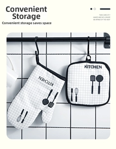 Thick oven mitt and pot holder set with black and white grid pattern hanging on hook