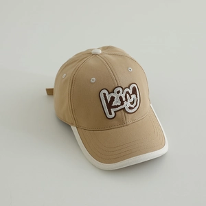 Detailed embroidery of King lettering on a khaki cotton baseball cap for kids