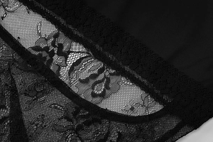 Close-up of black floral lace and mesh texture on a backless sleeveless maxi dress