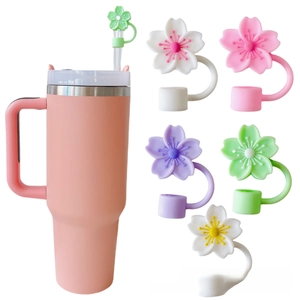 Detail showing colorful floral silicone straw covers on a pink 40oz insulated tumbler