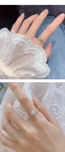 Close-up of sparkling moissanite ring with halo setting on woman's finger