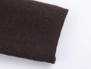 Macro shot of dark brown knit fabric with fine fibers and detailed weaving texture