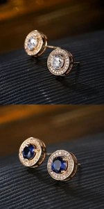 Macro shot of circular zircon stud earrings in blue and white with pavé setting