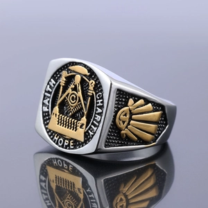 Macro detail of bicolour Freemason ring with Faith Charity Hope relief engraving