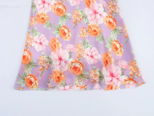 Detailed close-up of floral chiffon dress hem with purple pink and orange flower patterns