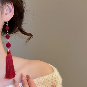 Close-up of elegant red velvet beaded tassel earrings for women in retro bridal style