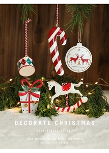 Detailed view of hand-painted metal Christmas ornaments with deer and drum motifs