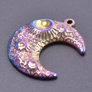 Macro view of rainbow stainless steel moon pendant with detailed geometric relief texture