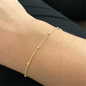 Elegant gold S925 sterling silver beaded chain bracelet worn on a female wrist