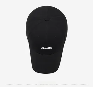 Detailed top view of a black baseball cap featuring white Seattle embroidered lettering