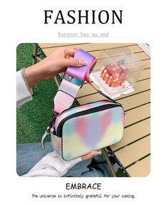 Detail of colorful gradient camera bag featuring a wide strap and rainbow PU leather finish