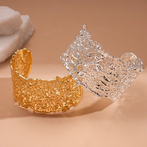 Polished gold and silver irregular hollow cutout cuffs with intricate lace texture
