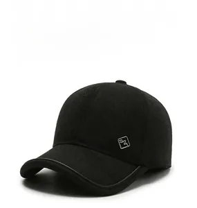 Detailed close-up of wool baseball cap with leather trim and metal logo plaque