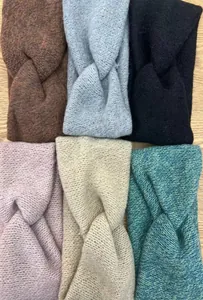Close-up of knit headbands in six colors with a stylish twisted knot design for winter