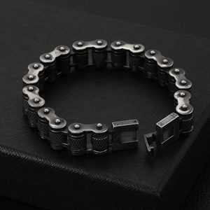 Detailed view of retro stainless steel bicycle chain bracelet on a black display box