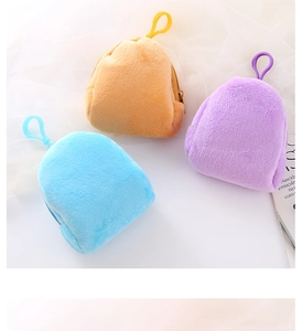 Three colorful mini plush backpack coin purses in orange, purple, and sky blue hues