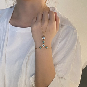 Golden stainless steel hand chain bracelet with white oil-drop flowers and blue gems