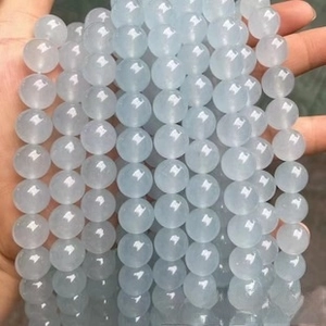 Close-up of translucent light blue natural stone beads strands for DIY jewelry making