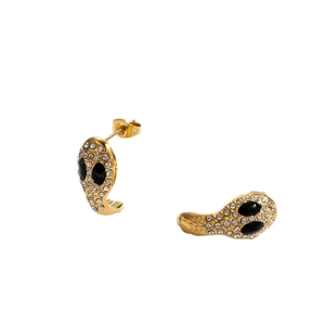 Chic snake-shaped gold earrings with black and clear crystals on a white background