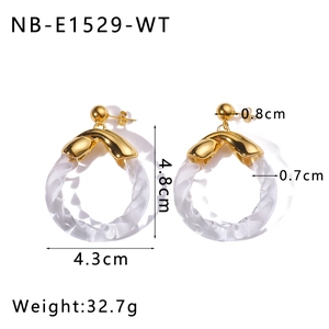 Macro shot of gold stainless steel hoop earrings with transparent spiral textured rings