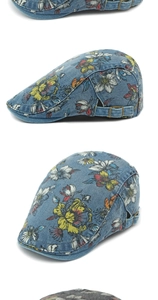 Detail showing vintage denim flat cap with floral patterns and adjustable metal buckle