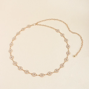 Detail of adjustable gold metal waist chain with sparkling rhinestones and lobster clasp