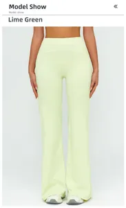 Front view of high waisted flared yoga pants in lemon green color with smooth fabric