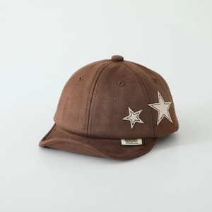 Detail of dark brown faux suede kids baseball cap with star patches and yellow woven label