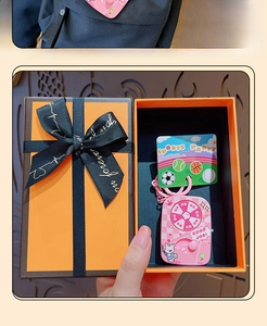 Detail of pink cat sport toy spinner keychain in a premium orange luxury style gift box