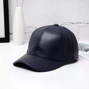 Close-up of premium dark blue PU leather texture on a minimalist baseball cap
