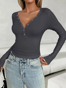 Detail of grey Y2K ribbed long sleeve top featuring V-neckline with silver button accents