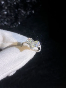 Detailed macro view of S925 silver heart ring featuring full moissanite pavé setting