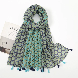 Detail showing geometric circular print and bicolor fringe tassels on the cotton linen scarf