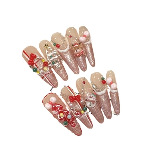 Handmade Christmas press-on nails featuring 3D snowmen and reindeer on pink glitter