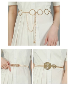 Detail of three gold leaf elastic belts with metallic rings and decorative tassels
