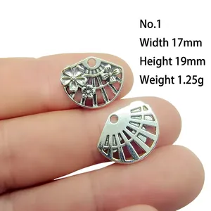 Close-up of vintage fan-shaped antique silver charms with dimensions 17x19mm and 1.25g