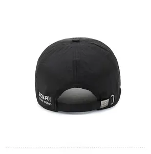 Detail of black sports cap featuring white embroidery and adjustable metal buckle closure