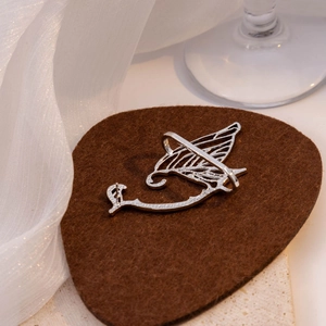 Elegant silver butterfly wing ear cuff with hollow design on premium velvet cushion