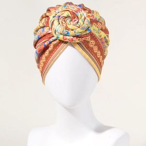 Bohemian floral pattern turban headwrap with large fabric flower detail in vibrant colors