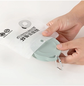 Close-up of portable green silicone folding cup in translucent bag with metal carabiner