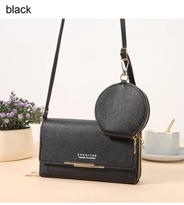 Detail of black crossbody bag with detachable round coin purse and gold hardware