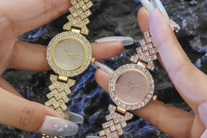 Detail of luxury gold and rose gold quartz watches with full rhinestone geometric bracelets