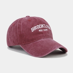 Detail of embroidered Brooklyn letters on washed burgundy vintage cotton baseball cap