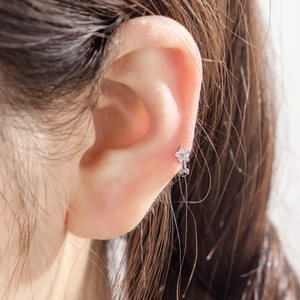 Micro-set zircon star hoop earring in silver finish shown on model's ear