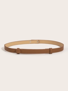 Close-up of brown cross-grain leather belt with silver metal buckle and fine stitching