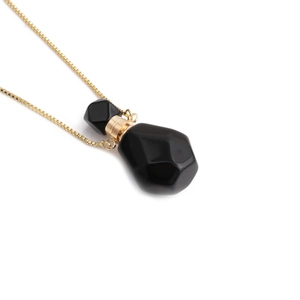 Elegant gold box chain necklace with a black gemstone flame-shaped perfume bottle pendant