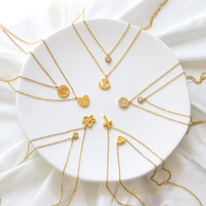 Golden stainless steel necklace set with tree of life, cross and heart pendants