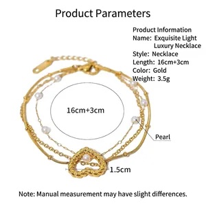 Detailed view of layered gold chain with white pearls and 1.5cm heart pendant