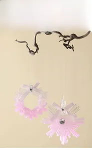 Close-up of pink translucent glitter acrylic Christmas tree ornaments with ribbon bows